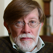Image of author J. Dennis Robinson wearing glasses and a sweater.