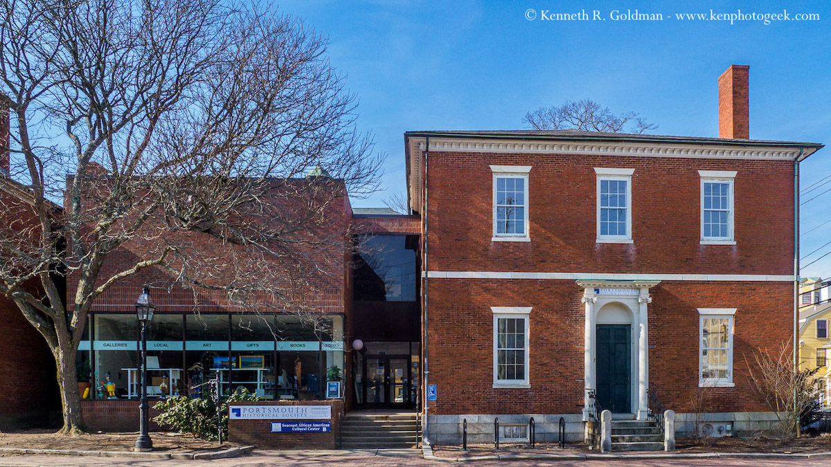 Image of the Portsmouth History Center with a two-story brick building from c.1810 making up the right-hand portion of the image with a more down brick and glass building from the 1950s.