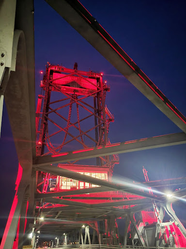 Memorial Bridge (metal lift bridge) lit up red at night.